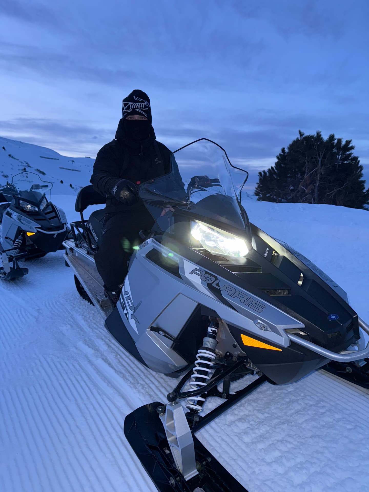 Snowmobiling at dusk